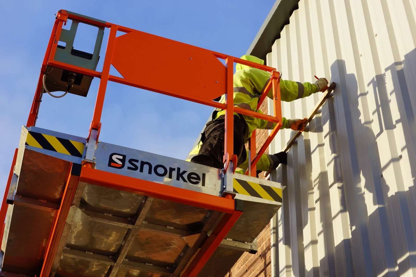 A CPR operative working on external cladding from a cherry picker